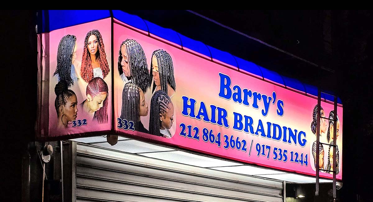 Illuminated storefront sign created for a hair braiding business